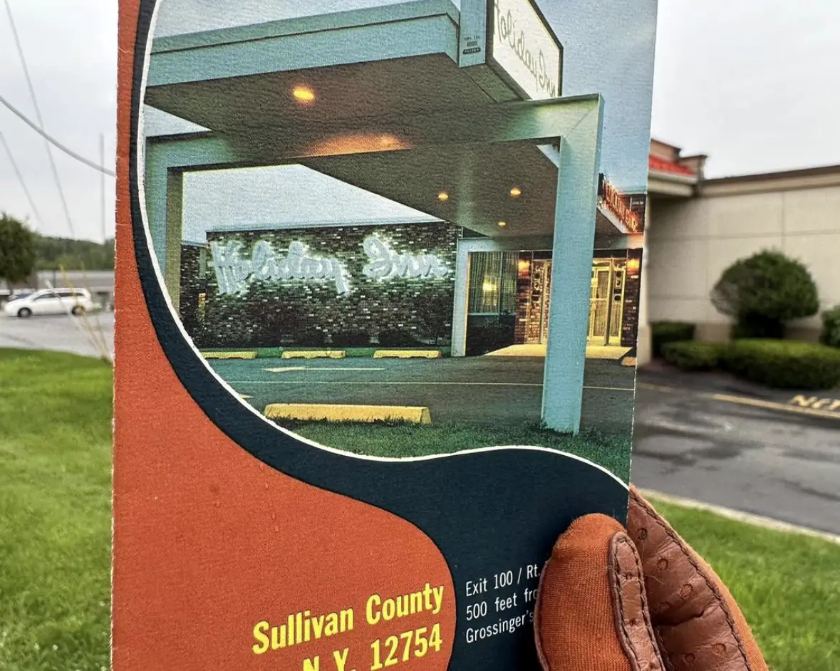 A vintage roadside brochure featuring the entrance to a hotel in Sullivan County, N.Y., displaying the hotel name illuminated at night.