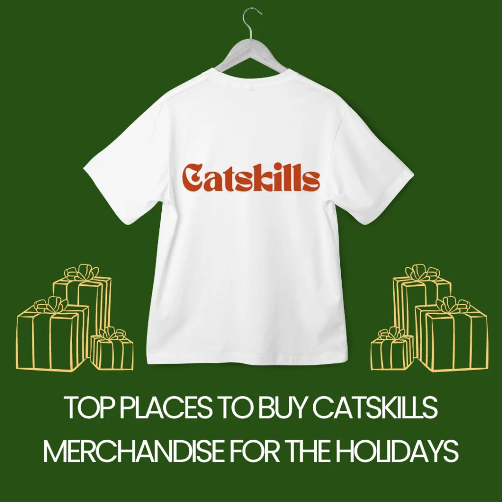 A white t-shirt with the word 'Catskills' printed on the back, displayed against a green background with holiday gift boxes.