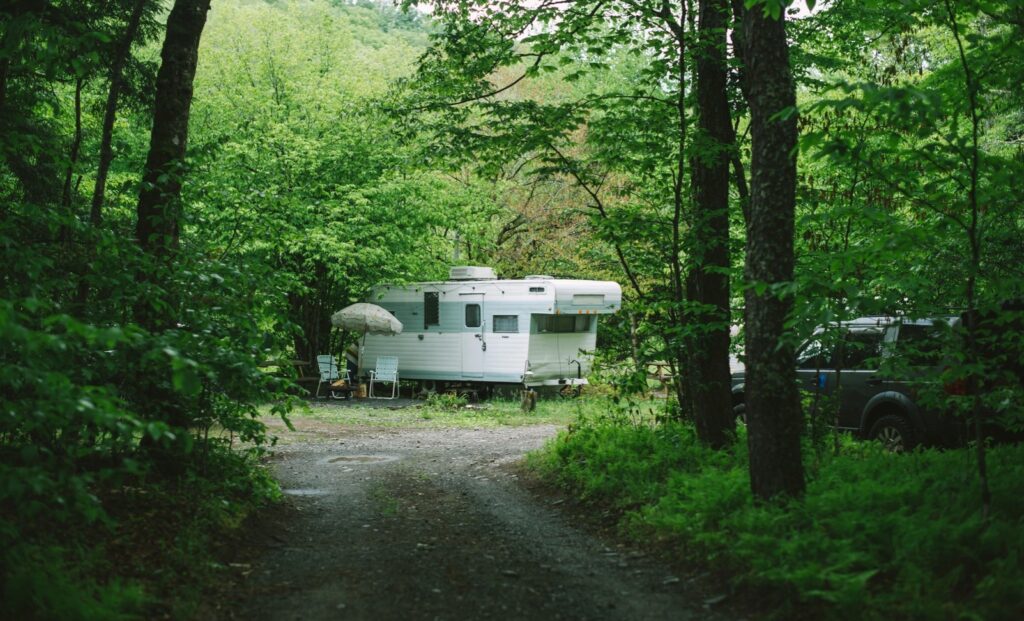 A camper parked in the woods at Boheme Retreats in the Sullivan Catskills