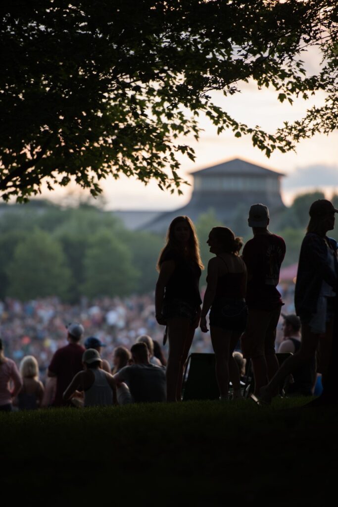 Silhouetted concertgoers at a show at the Bethel Woods Center for the Arts, site of Woodstock.