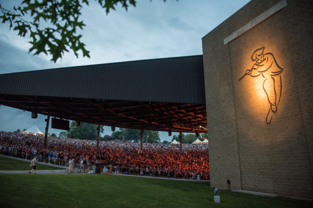 People enjoying an evening concert in the covered amphitheater at Bethel Woods Center for the Arts.