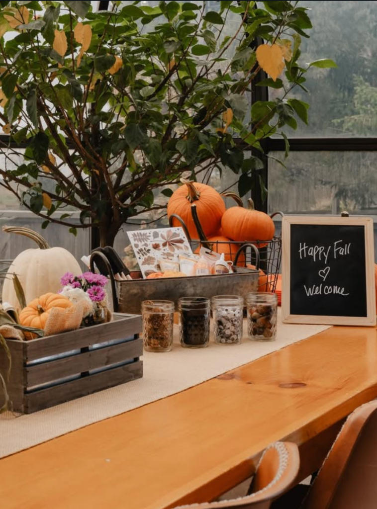Elegant dining room at The Arnold House in Livingston Manor with marble tables, soft lighting, and cozy green velvet seating prepared for Thanksgiving dinner