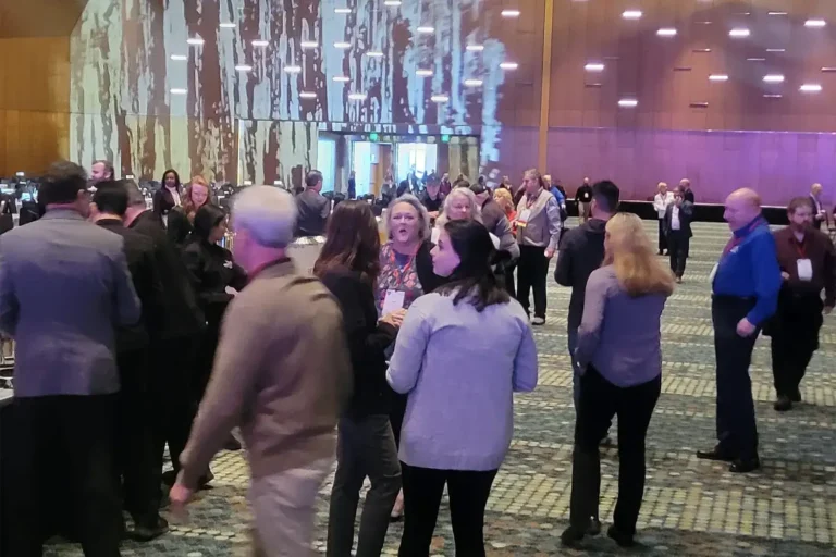 group at a meeting socializing with each other