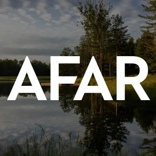 A serene landscape featuring a calm lake reflecting trees and clouds, centered around the word 'AFAR' in bold white letters.