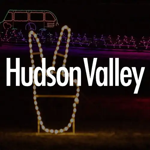 A large light display featuring a peace sign and the text 'Hudson Valley' illuminated against a dark background.