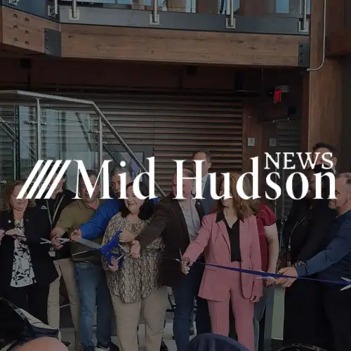 A ribbon-cutting ceremony with a group of people gathered, celebrating an event or opening.