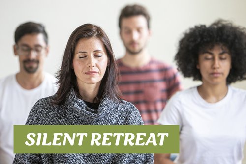 A group of individuals meditating together during a silent retreat, with focus on mindfulness and inner peace.