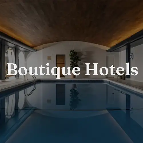 Indoor swimming pool featuring modern design elements and stylish lighting, creating a luxurious ambiance for boutique hotels.
