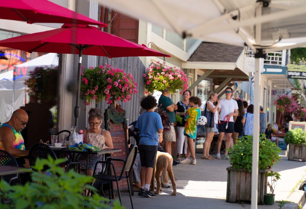 Main street Callicoon with people dining al fresco on the sidewalk and shopping. 