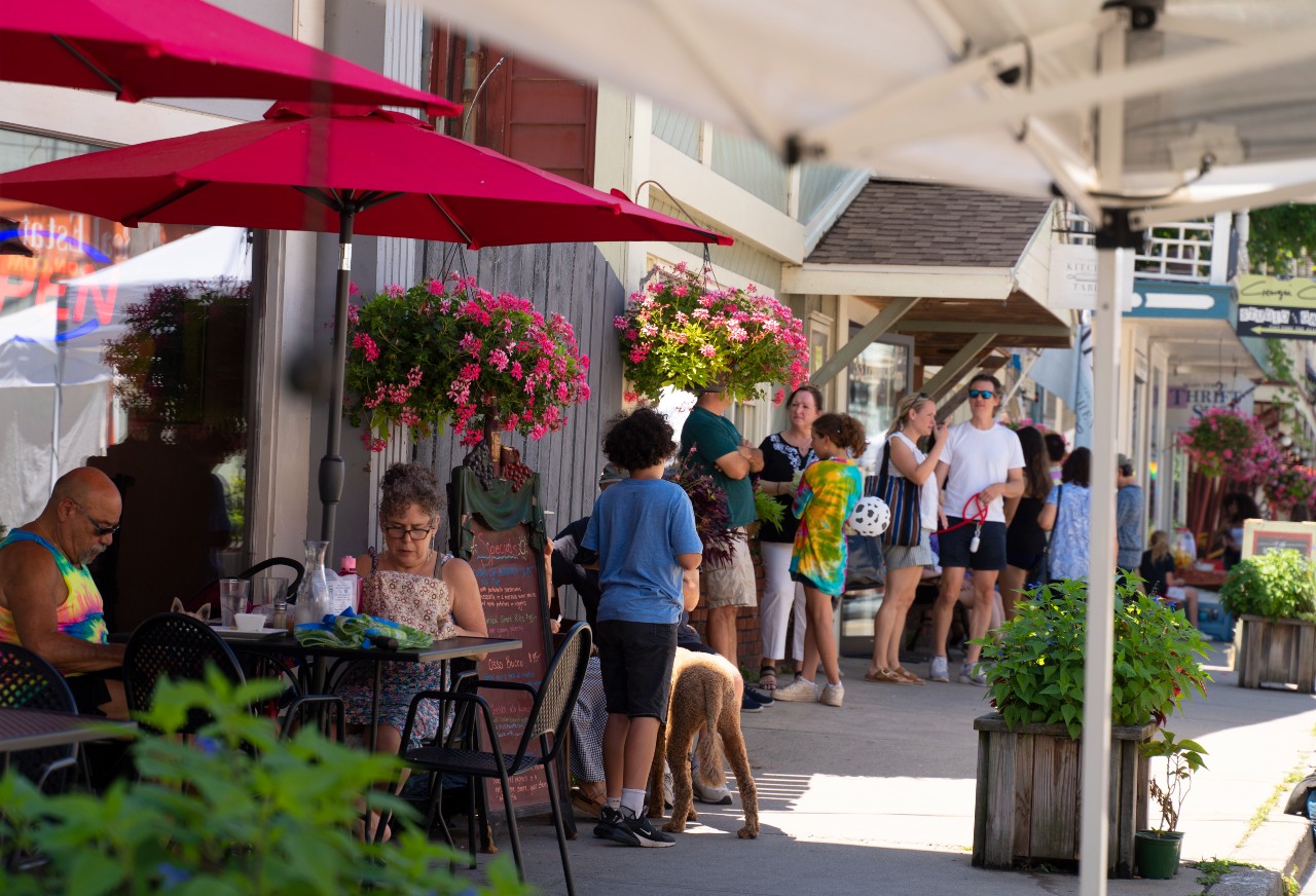 Main street Callicoon with people dining al fresco on the sidewalk and shopping.