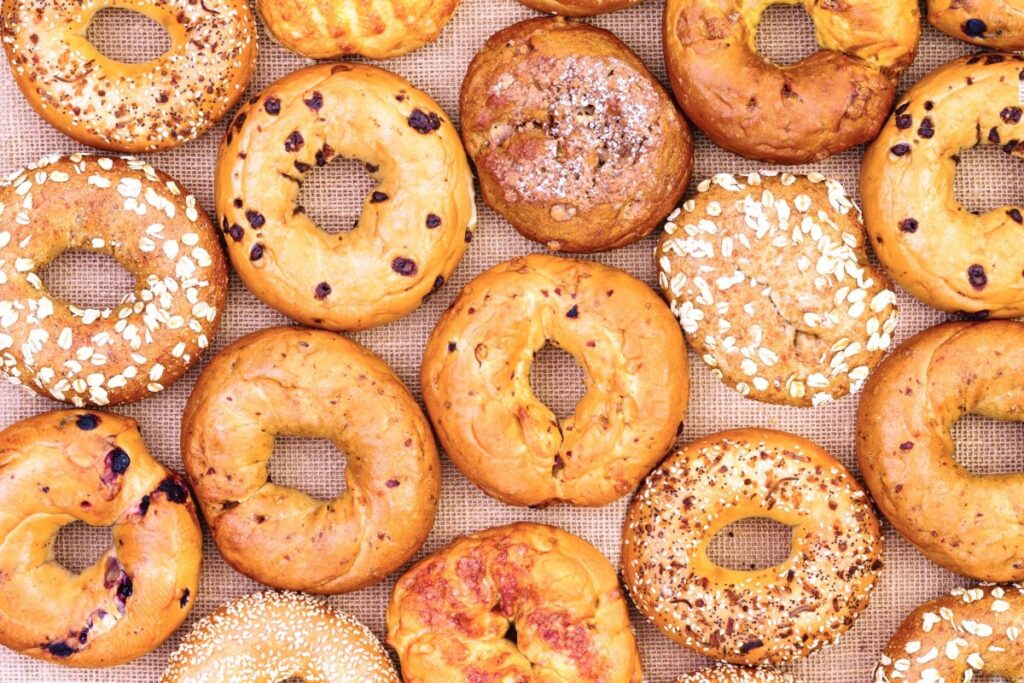Close up view from above of a bunch of different types of bagels at the Monticello Bagel Festival. 
