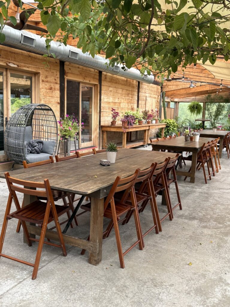 Long wooden tables on the patio of The Arnold House Tavern in Sullivan Catskills.