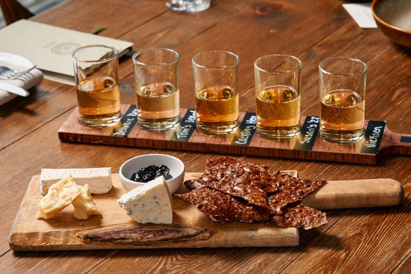 A flight of cider for tasting and charcuterie.